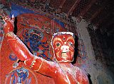 Tibet Guge 06 Tsaparang White Temple 02 01 Hayagriva Immediately on the left of the door is a 5m-high terrific image of red Hayagriva (Tib. Tamdrin), looking at us with its three wide open eyes. Hayagriva used to have a horse head emerging from his hair, and his right hand would have held a vajra. As the guardian of the door, Hayagriva is portrayed at the entrance to the temple to keep away evil influences and to protect the sanctity of the place. Photo - Weyer/Aschoff: Tsaparang, Tibets Grosses Geheimnis.